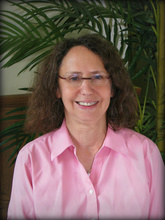 Miriam Landsman, PhD: Middle aged white woman with brown hair in a pink shirt