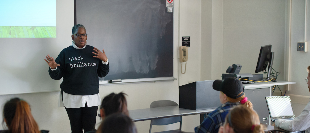 Instructor speaks during a Foundations of Critical Cultural Competence class