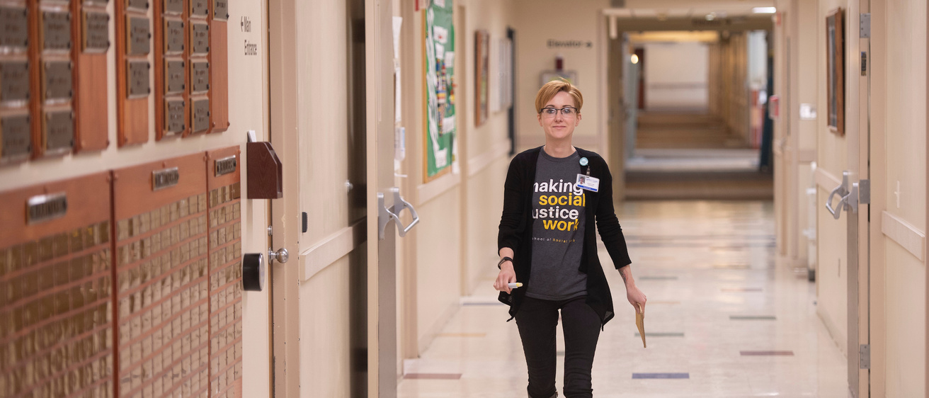 Morgan Newman walks through the Madison County Memorial Hospital in Winterset, Iowa, where she works one day per week while attending the UI School of Social Work’s online MSW program.